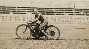 Guy Menzies riding a motorbike at a speedway, Sydney, 1920s