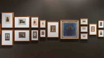 Exhibition gallery wall with images mounted in frames