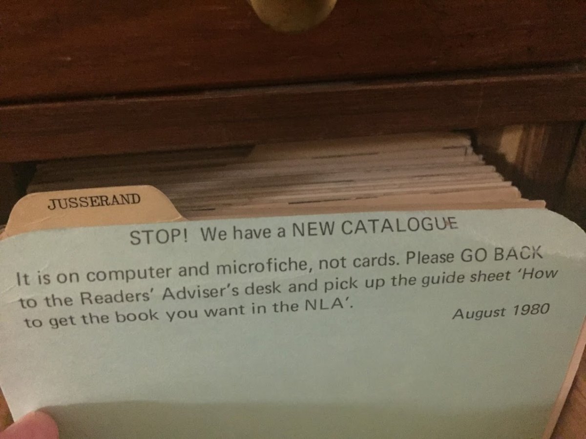 A yellow manila folder is open to a typed note that directs readers to use a computer