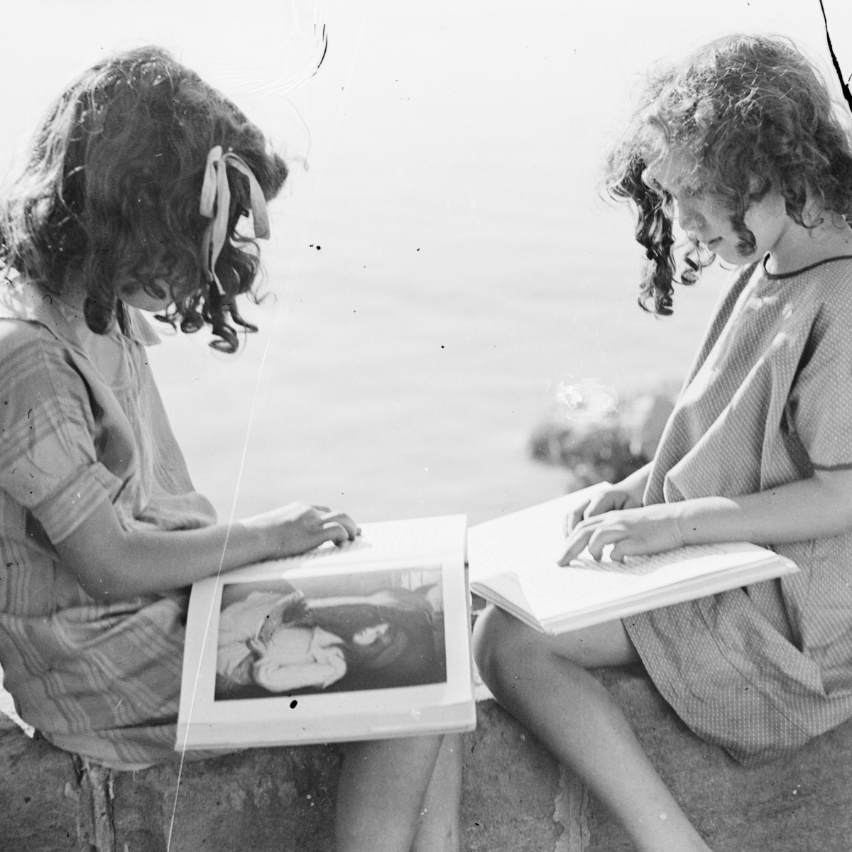Two girls sitting and reading