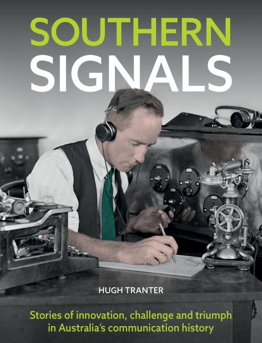 The front cover of the book 'Southern Signals'. The text on the cover is white and green and reads 'Southern Signals. Hugh Tranter. Stories of innovation, challenge and triumph in Australia's communications history.' The image is of a man sitting at a table with over-ear headphones on. He is writing on a piece of paper, and the table is covered in different pieces of communications equipment.