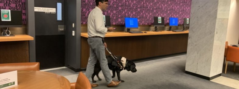 Scott Grimley walking with dog in Library