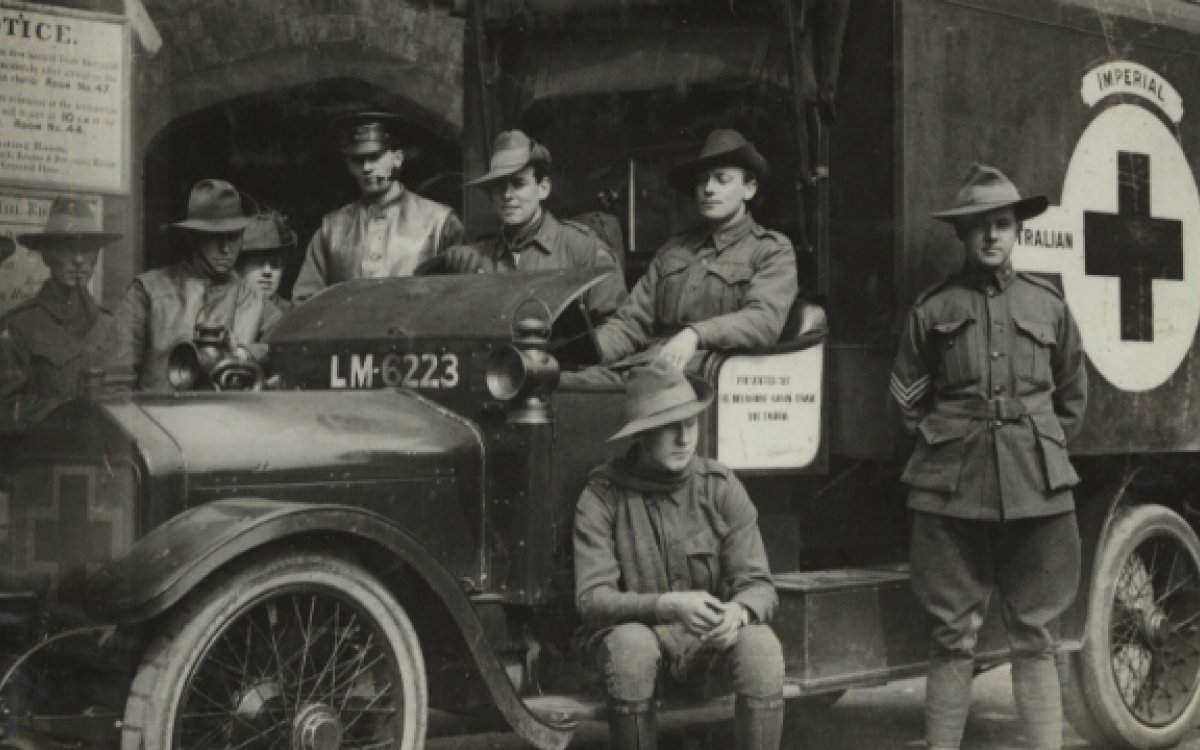 Nine soldiers gathered around an ambulance