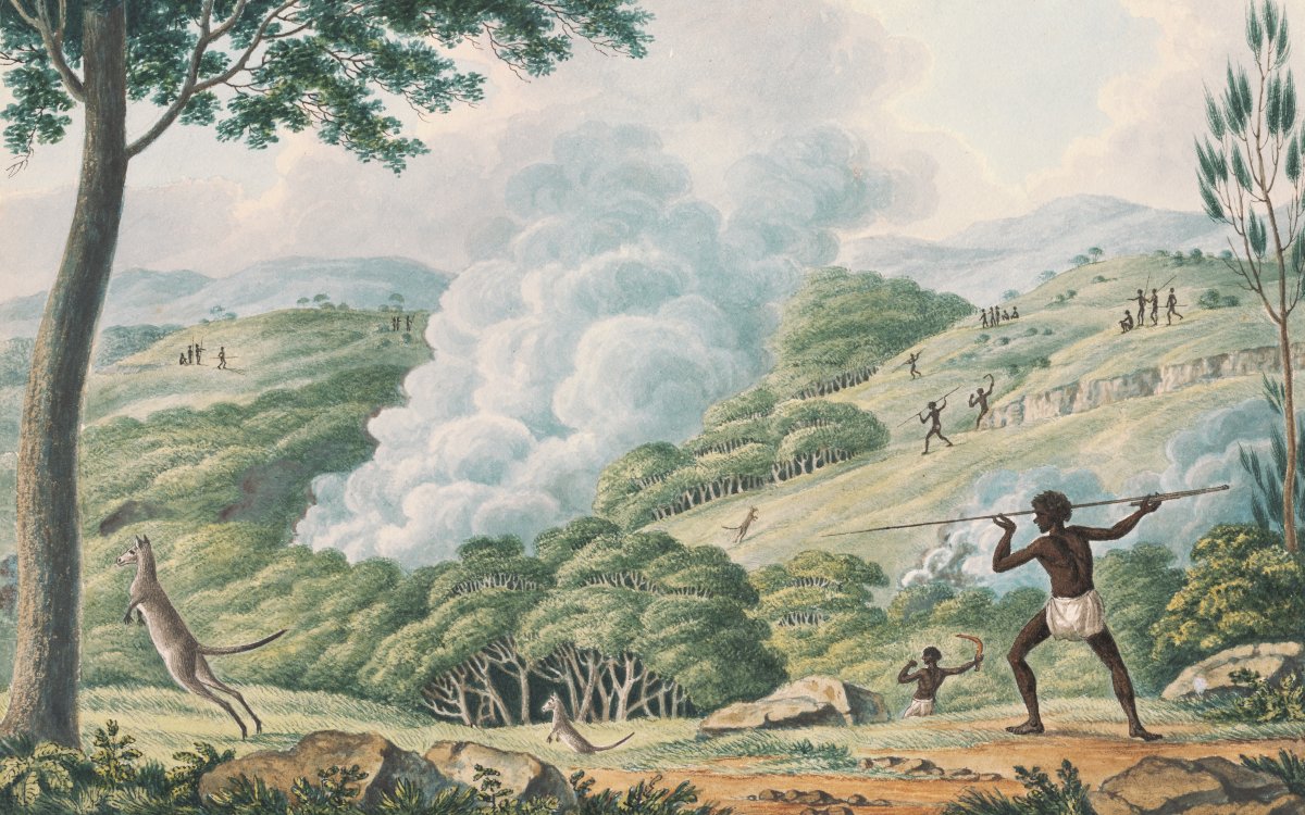A watercolour image depicting a hilly bushland scene. In the foreground a man in a white loincloth is in the action of throwing a spear at a kangaroo in mid-jump. There are many kangaroos throughout the image. There are also many figures throwing spears and boomerangs at various animals. In the middle of the image, rising from a dense thicket of trees, a large plume of white smoke boils upwards and mixes with the clouds in the sky.