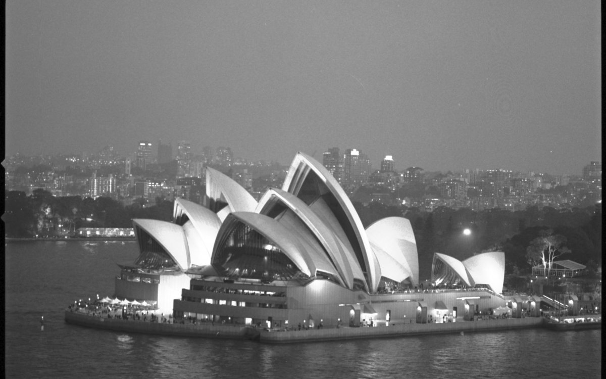 A black and white arial photograph of the Sydney Opera House