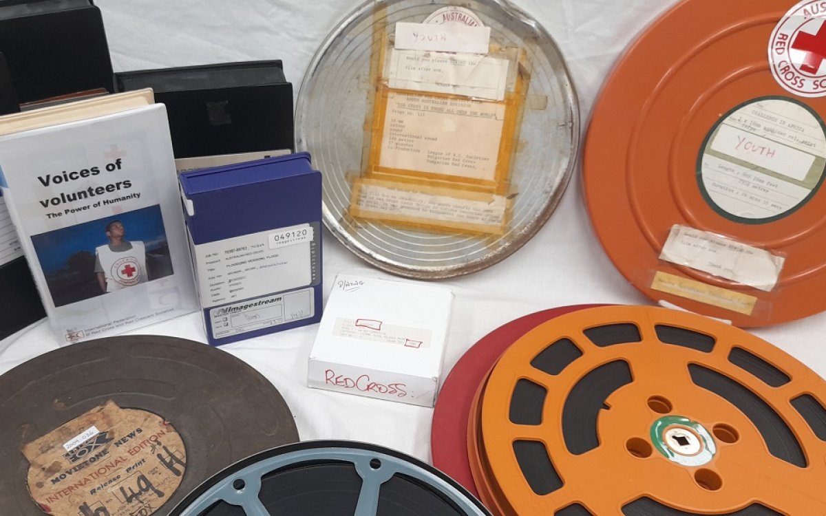 A selection of Australian Red Cross Society films in circular and rectangular cases.