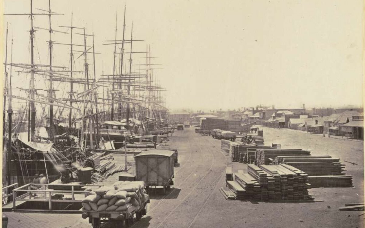 yellowed photograph of docks and trucks 