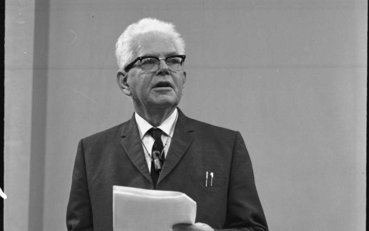 black and white photograph of a man lecturing at a lecturn