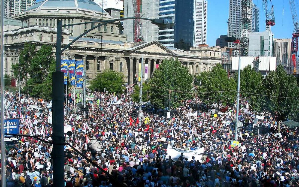 A photo of a large number of protestors gathered in front of the Victorian state library.
