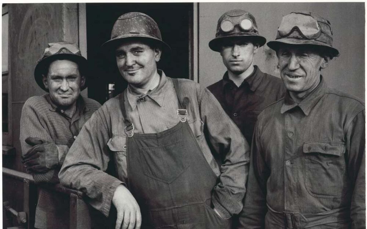 black and white photograph of four miners