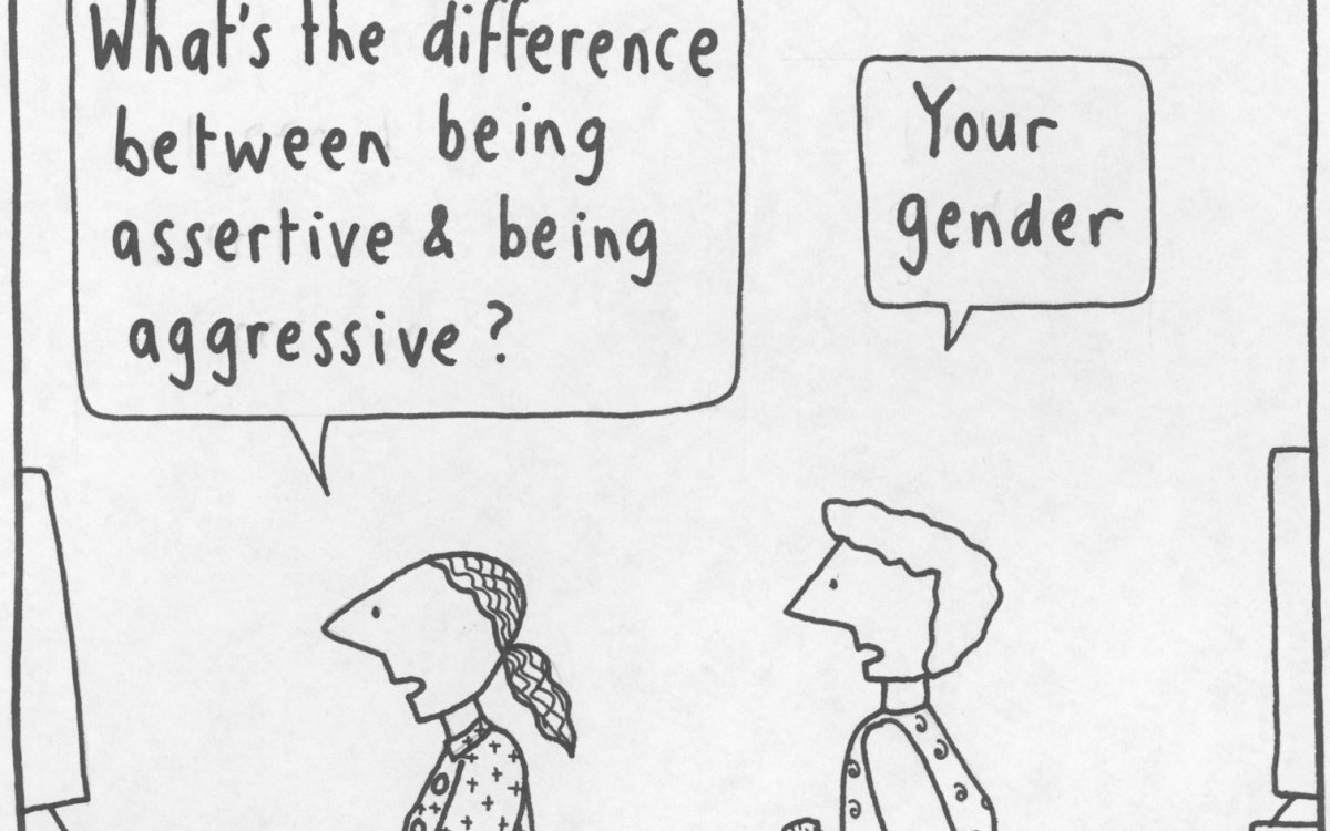A cartoon showing 2 women back to back at their computer's with one saying 'What's the difference between being assertive and being aggressive?' the other turns and replies 'your gender'.
