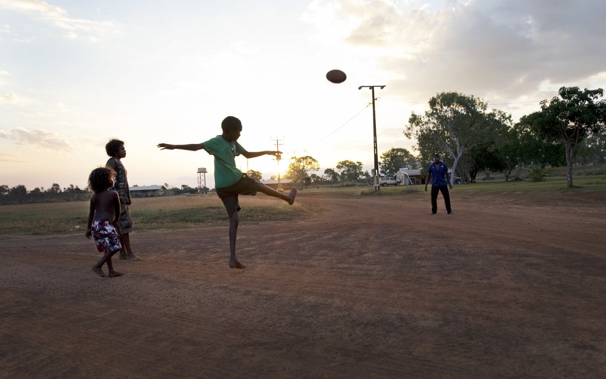 Photo of Aboriginal children playing football, Wudikapildiyerr outstation, Daly River, Northern Territory, 25 June 2010