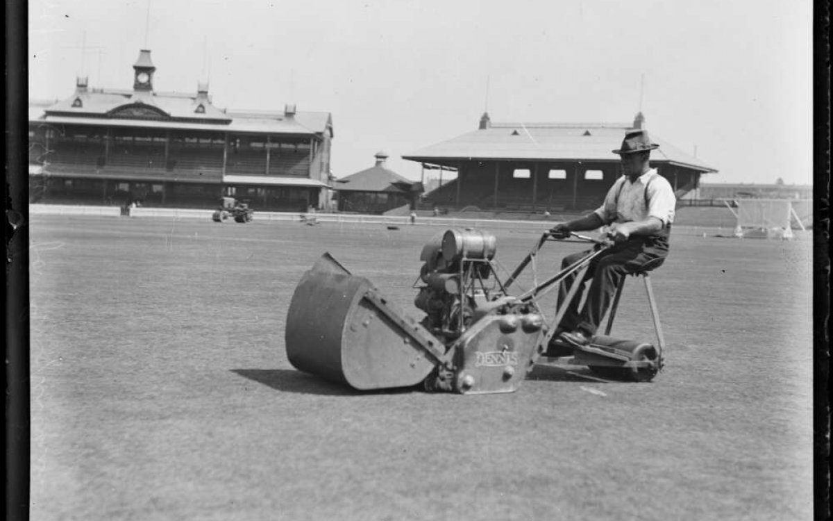 black and white photograph of a man mowing the lawn at the Sydney Cricket Ground