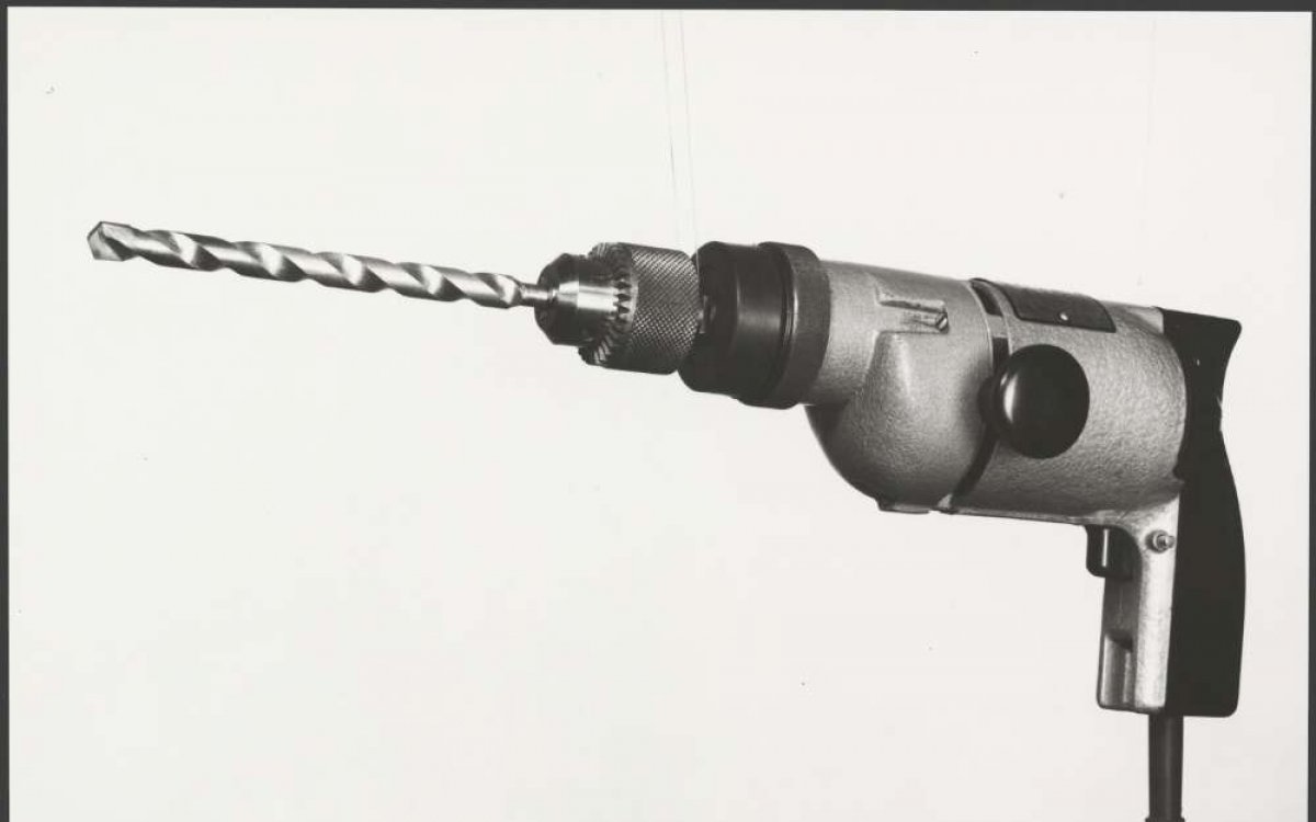 black and white photograph of an early electric drill
