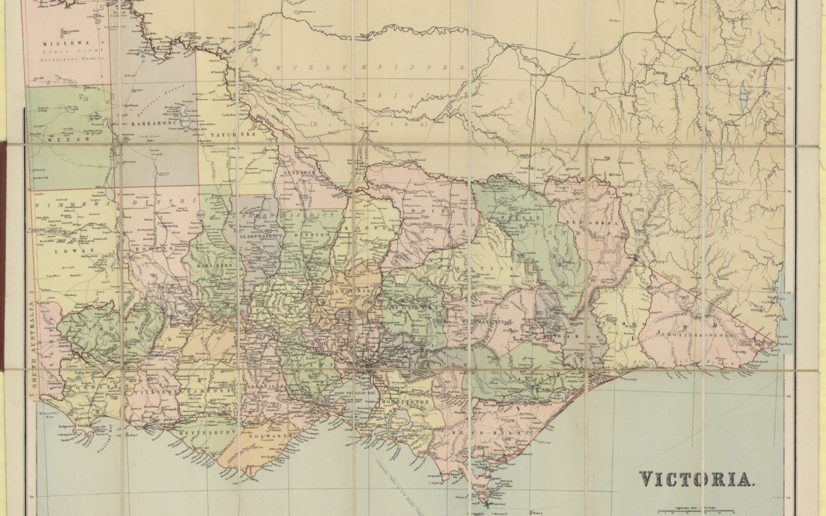 A photo of a map of Victoria with pastel colour shaded areas of green, pink, purple, orange and yellow
