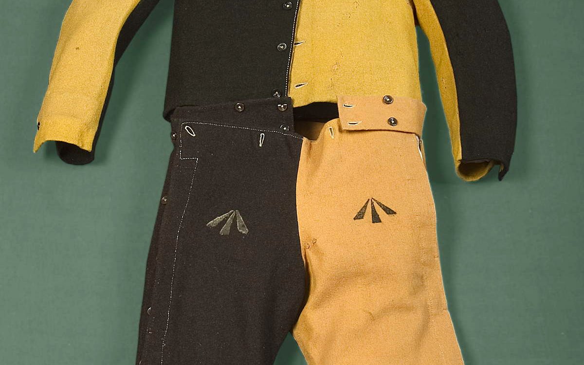 A yellow and black convict uniform with arrows on the pants and 2 head caps