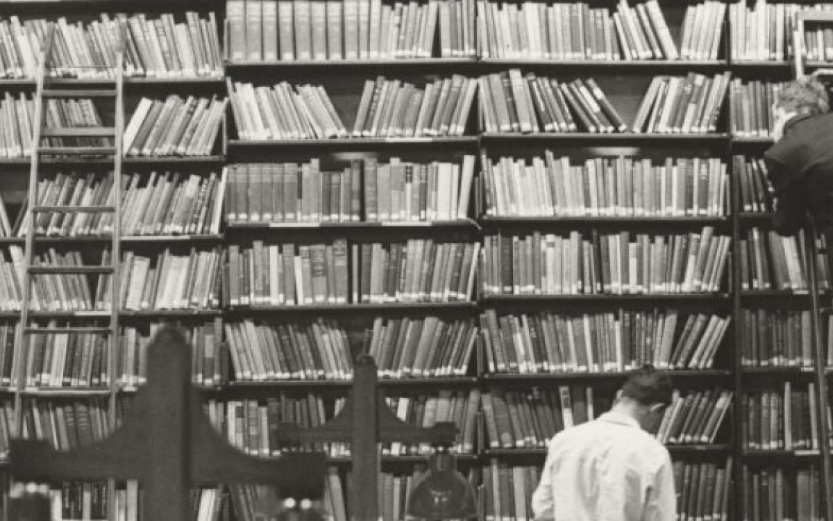 Two men browsing bookshelves
