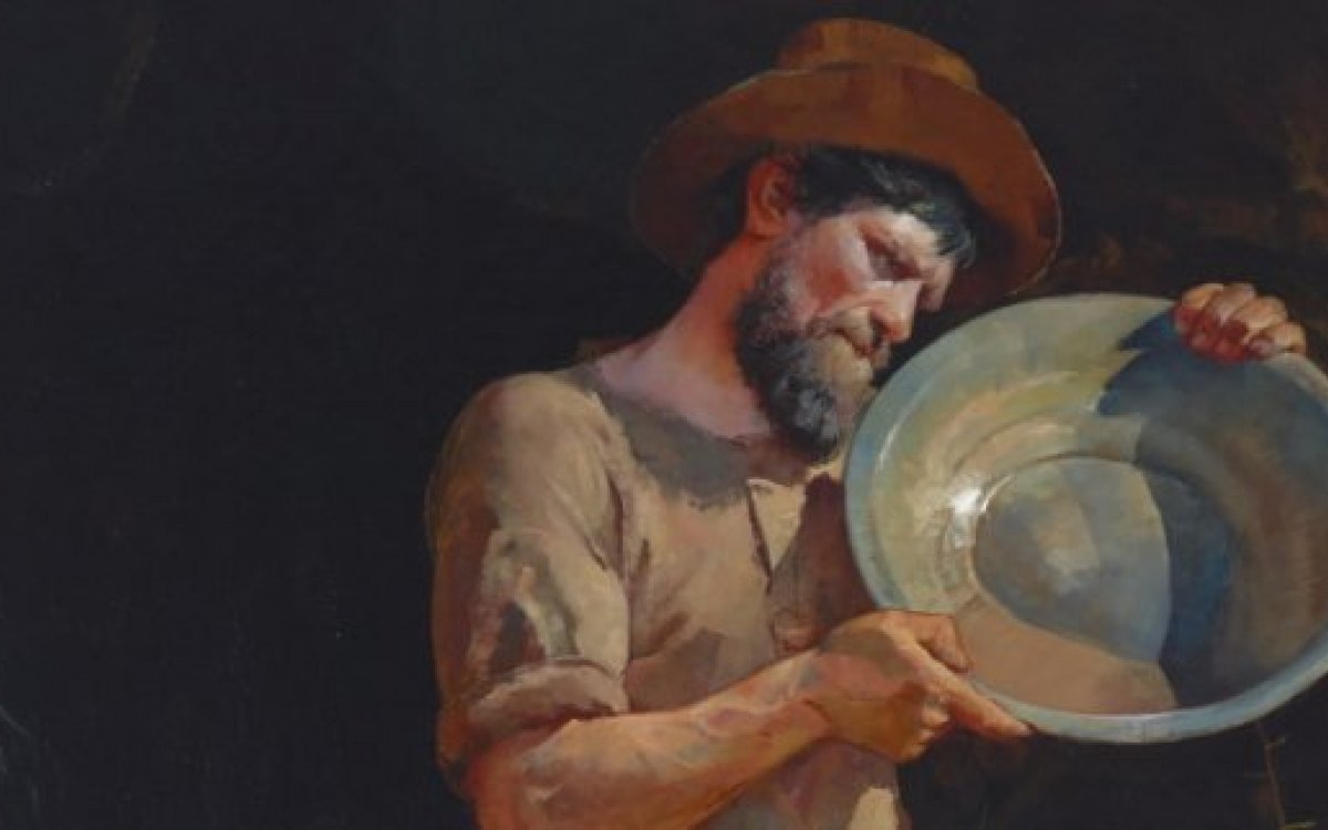 A prospector holding a pan. 