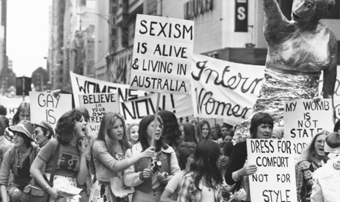 Women on the march wave their placards at the International Women's Day march, Melbourne, March 8, 1975 [picture] / Australian Information Service photograph by John McKinnon 