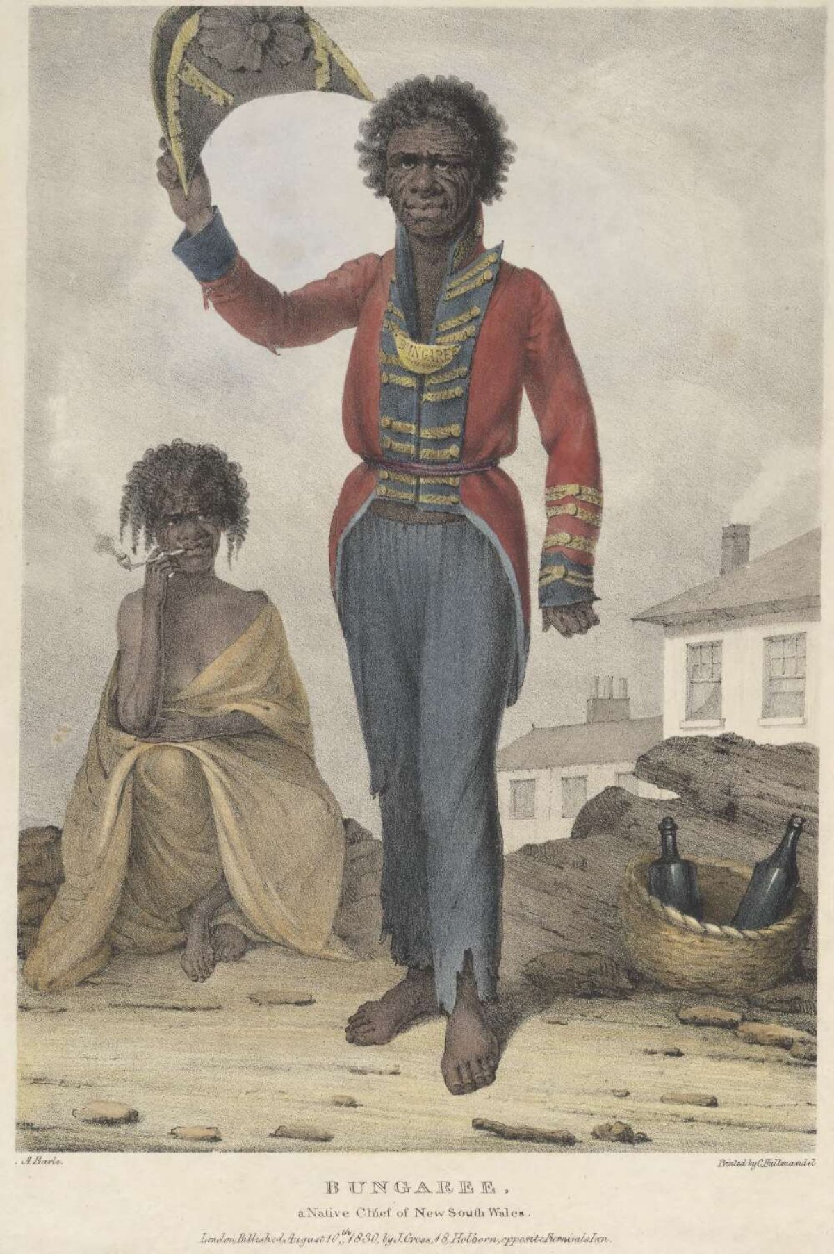 A portrait of a man. He has dark skin and hair. He is an Australian Indigenous man and is wearing a red, blue and gold European style officers coat and trousers. His trousers are tattered at the cuffs. He is holding a tricorn hat in the air. In the background an Indigenous women is seated, wrapped in a shawl. She is smoking a pipe. There is a woven basket with two empty bottles. In the background there is a white washed house with smoke curling from the chimney.