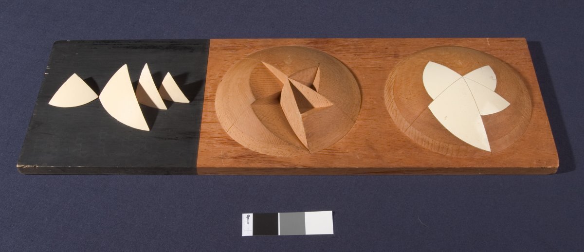 A stylised, abstract architects model of the Sydney Opera House. The model shows a hemisphere with triangular segments removed, another hemisphere shows the segments replaced to create a smooth surface.