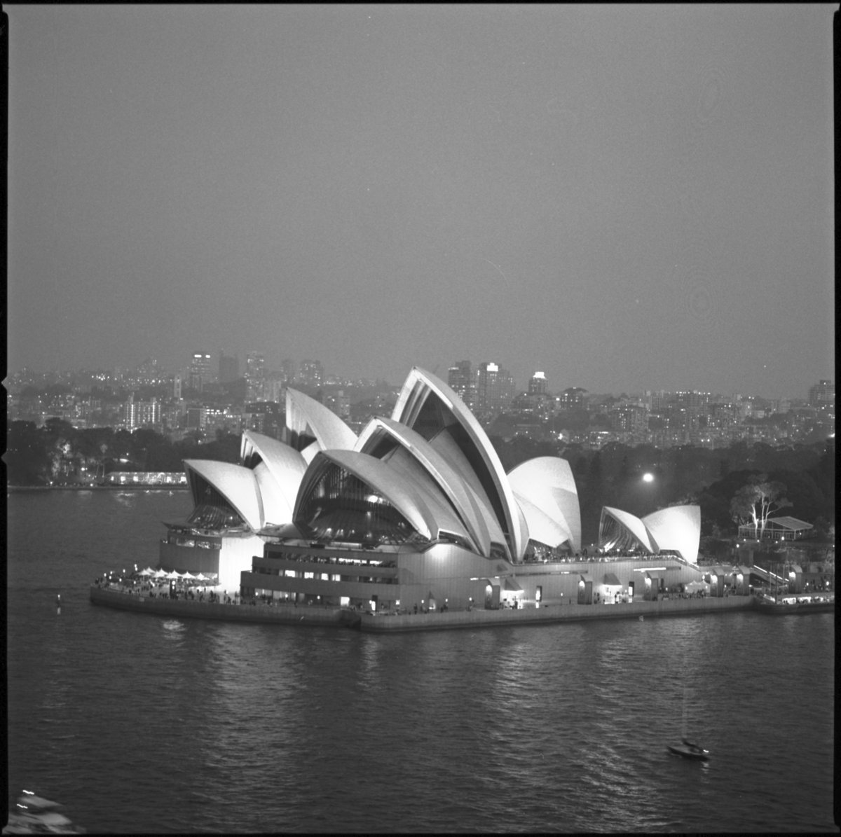 A black and white arial photograph of the Sydney Opera House