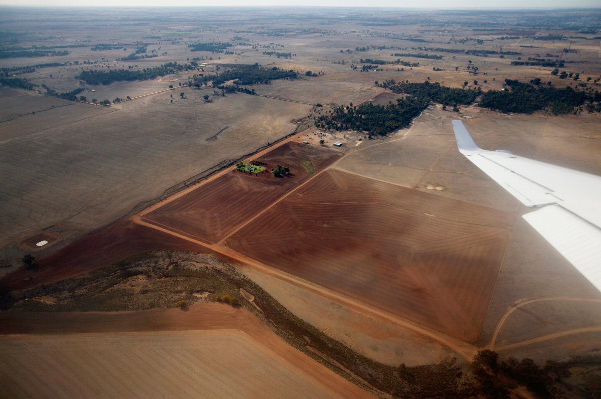 An aerial view of a dry dusty landscape taken from a plane. 