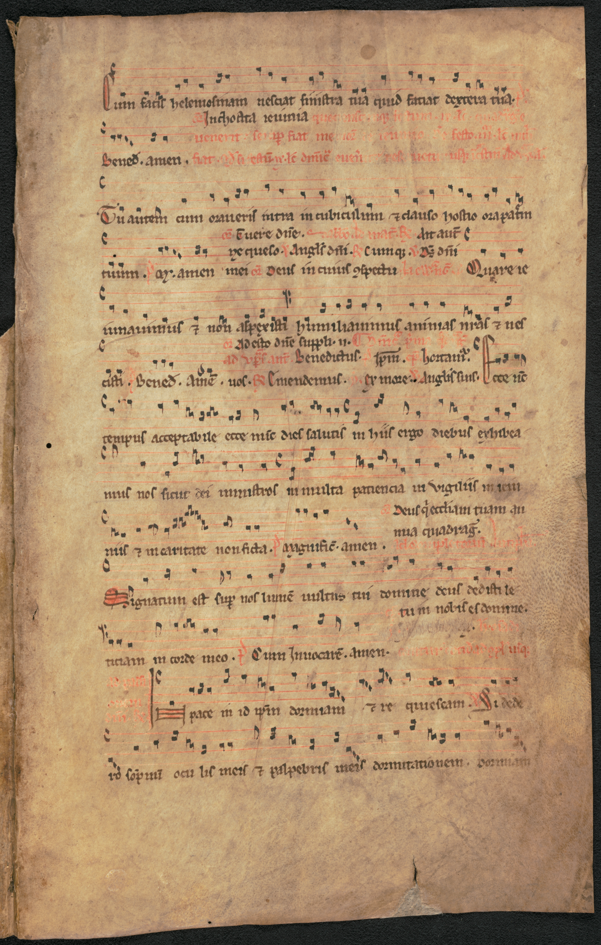 A detail of an old handwritten document with musical notation. The lyrics are written in red and black ink. The notation is in black.