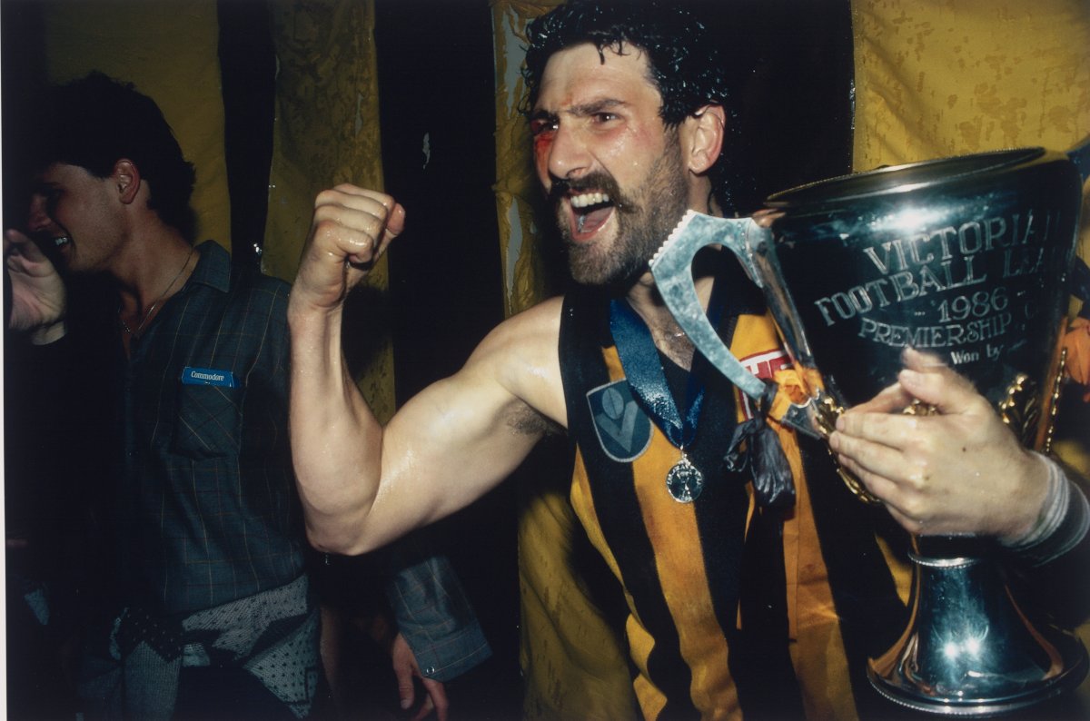 Photo of Robert Dipierdimenico holding a trophy and cheering