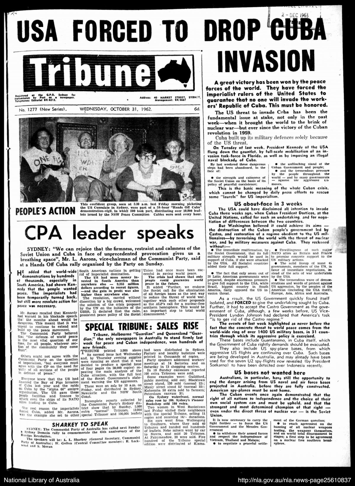 The front page of the Tribune newspaper. The headline reads "USA FORCED TO DROP CUBA INVASION". There is a black and white photograph of 5 people holding protest signs.