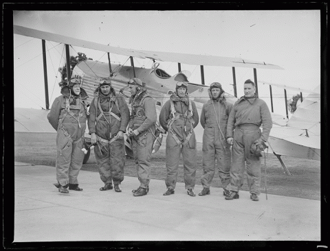 Commonwealth Government Geological Adviser Dr Walter Woolnough and his research party in full flying attire in front of a survey plane, 1932.