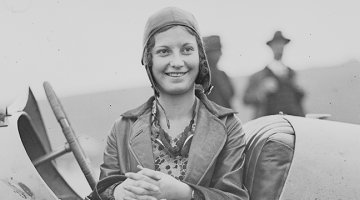 Woman sitting in a race car at the Gerringong Motor Races, New South Wales, 10 May 1930