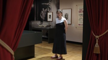 Dr Susannah Helman stands in the On Stage exhibition gallery.