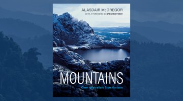 Book cover 'Mountains' superimposed over a landscape view of mountains