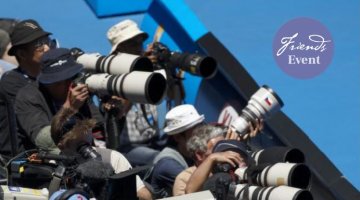 Image features media photographers crowded together with long lenses