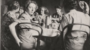 newspaper photo of women sitting around a table