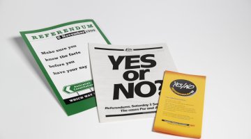 Three pamphlets on a white background. The middle one has text reading 'Yes or No'