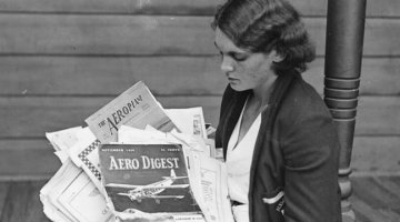 Clare Dennis holding copies of Aero magazines