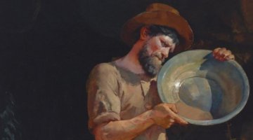 A prospector holding a pan. 