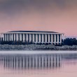 View of the National Library of Australia with a reflection of the building appearing in the water. 