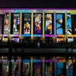 The National Library of Australia building at dusk, lit up with colourful projections.