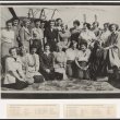 Black and white photo of 21 women of various ages smiling, standing in front of a plane. Below the image is a list of these women's names and where they're from. 