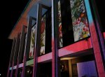 Multi-coloured projections light up the exterior of a building