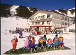  A photo of Falls Creek ski resort with several children being taught how to ski.