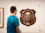 Boy looking at the Winfield State of Origin plaque