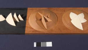 A stylised, abstract architects model of the Sydney Opera House. The model shows a hemisphere with triangular segments removed, another hemisphere shows the segments replaced to create a smooth surface.