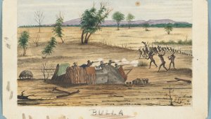 A framed image of a dusty landscape. Five men take shelter in a crude defense structure made of corrugated iron and wood. They are firing rifles at a group of Indigenous men charging over a hill. Sparse trees dot the dusty landscape. Dark hills can be seen in the background. Beneath the image is the word "BULLA".