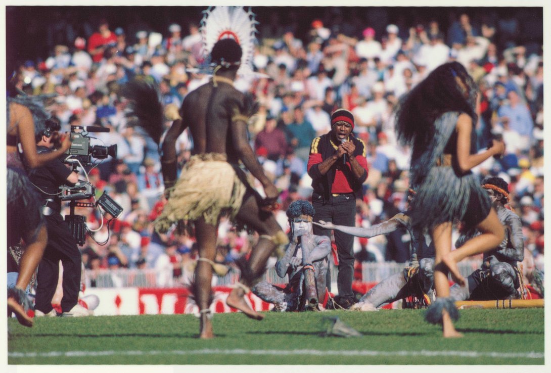 Archie Roach and dancers performing at the Australian Football League grand final, 1993
