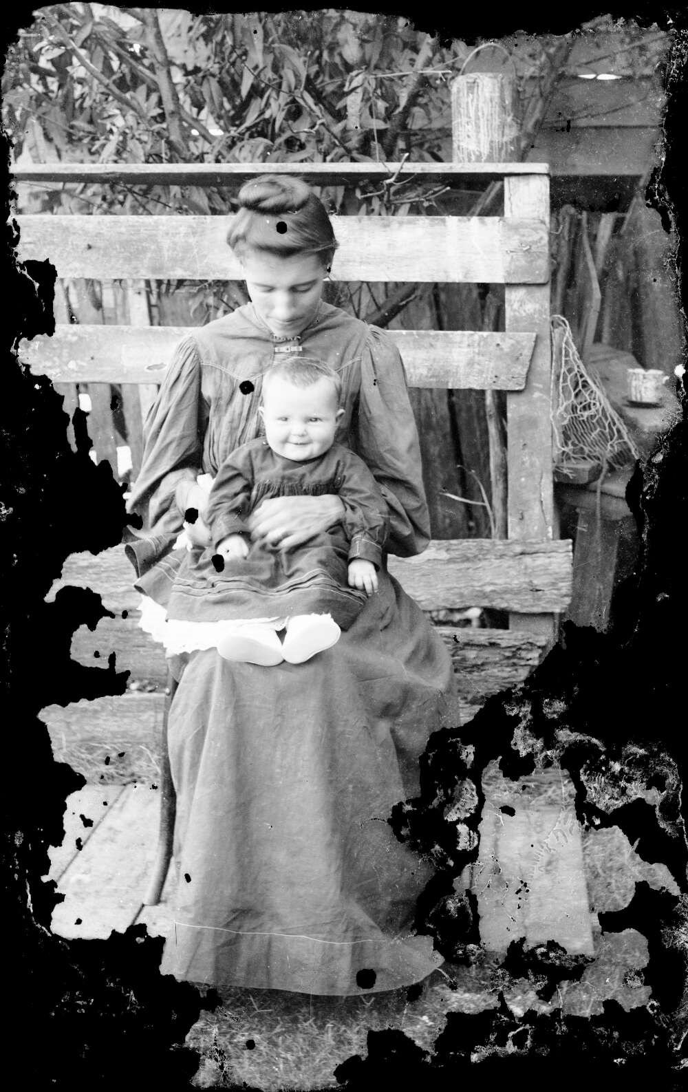 Unidentified woman with baby on lap