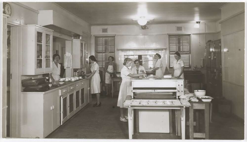 A group of women at work in a large commercial kitchen